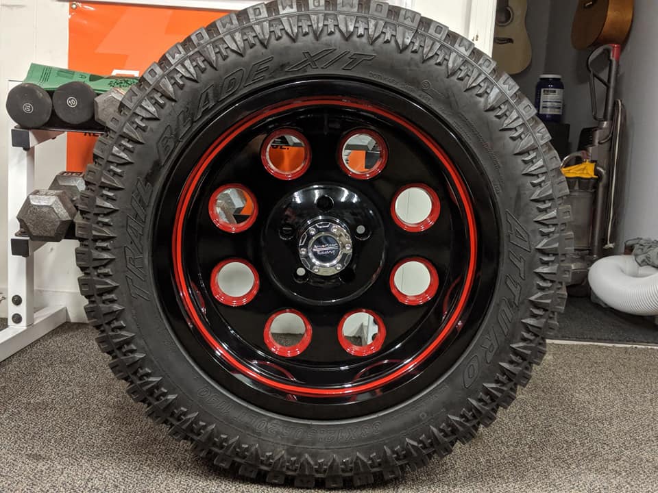 Red and black rims installed on tires